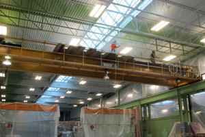 painter spray painting steel beams in a Niagara Falls factory