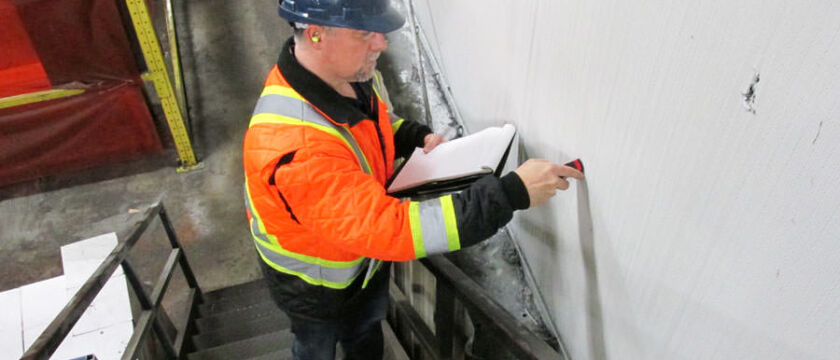 estimator testing paint and preparing a cost / price quote for wall painting
