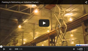 industrial spray painting a ceiling in a factory