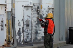 worker performing industrial sand blasting in Ajax